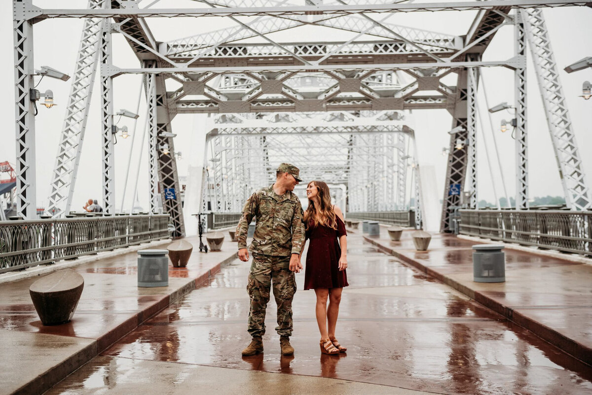 photo of military man and his fiancee on a bridge