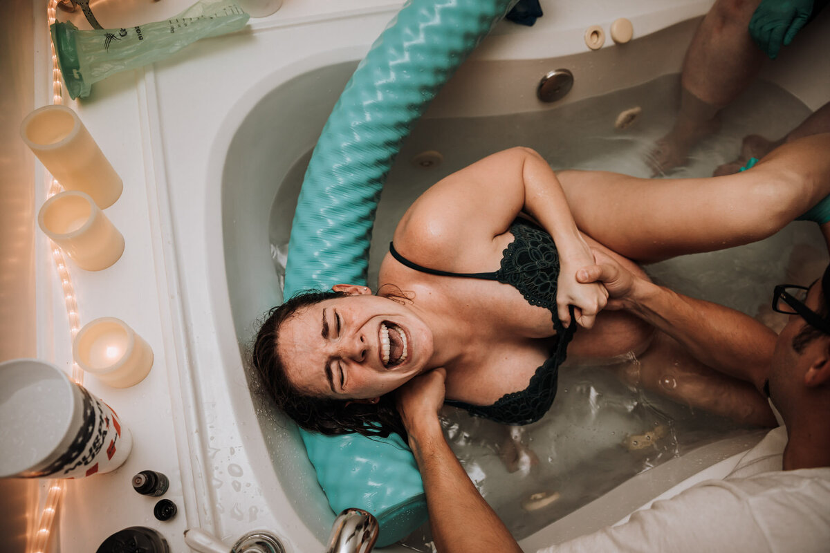 woman screaming in bath tub through labor