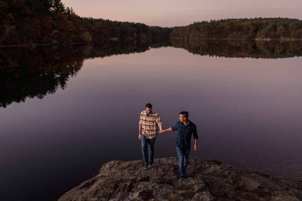 two men engagement session at a lake in the woods on a fall day. a gay couple and lgbtw friendly session. featuring a white man and asian man.