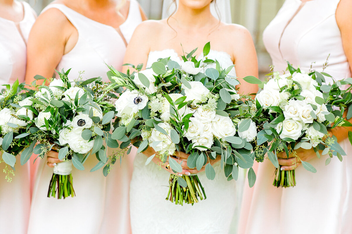 Close up of bride and bridesmaid white bouquets