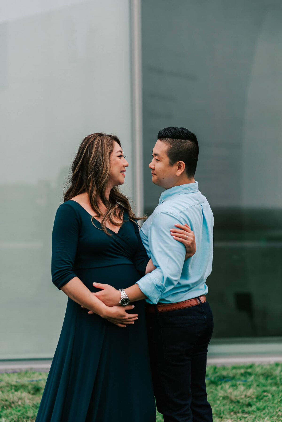 An expecting couple gazing lovingly at each other, captured by a Northern Virginia maternity photographer