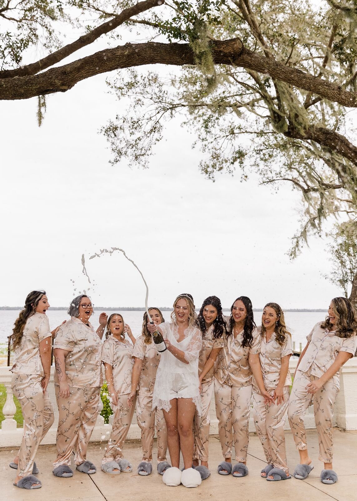 Bridesmaids with Bride popping champagne at Bella Cosa, Lake Wales, Florida