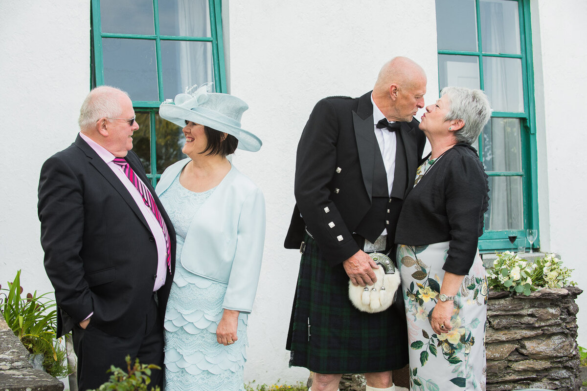 two couples at a wedding sharing a tender moment at Castlecove House