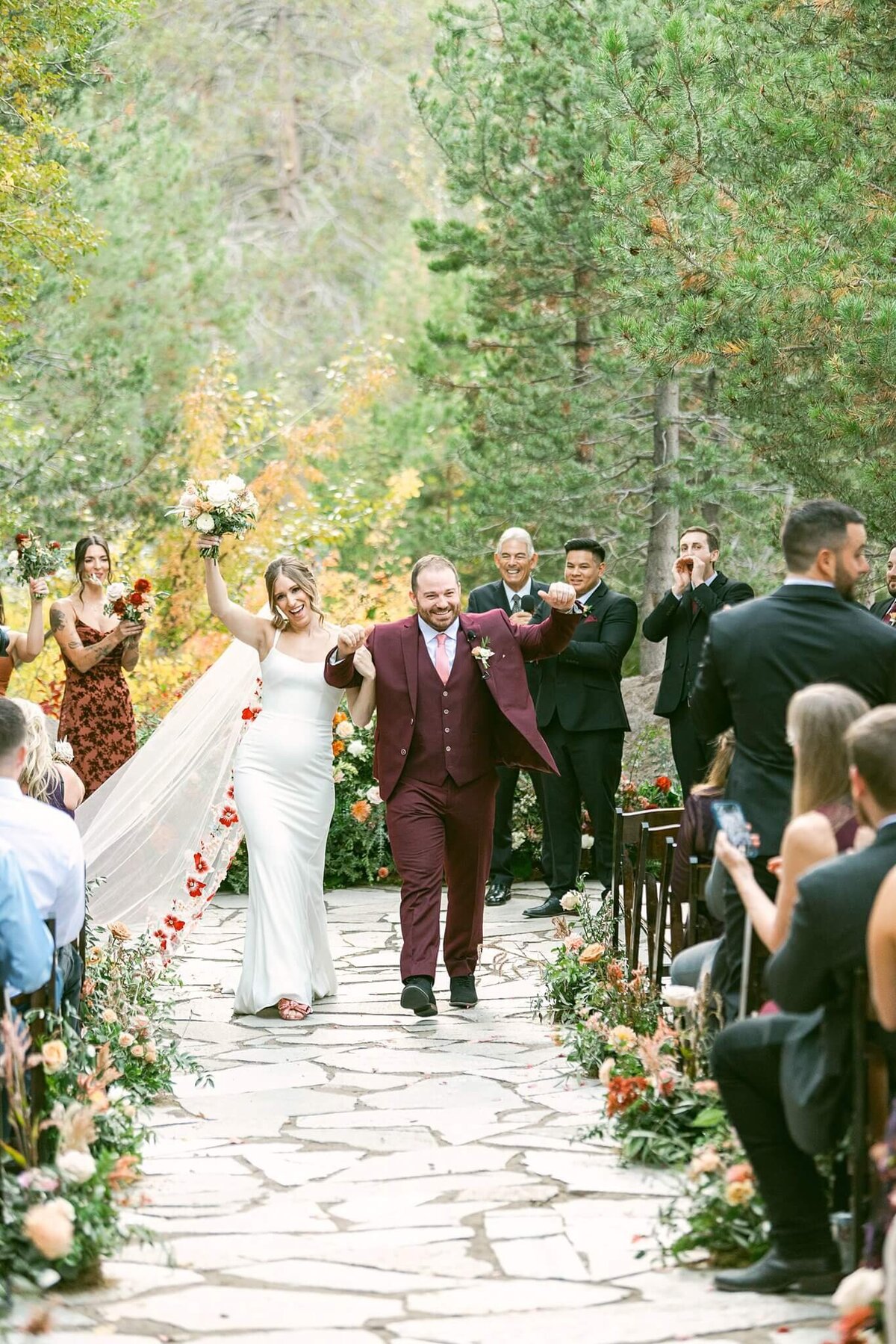 bride and groom walking up the aisle during a fall wedding at PlumJacks palisades tahoe 