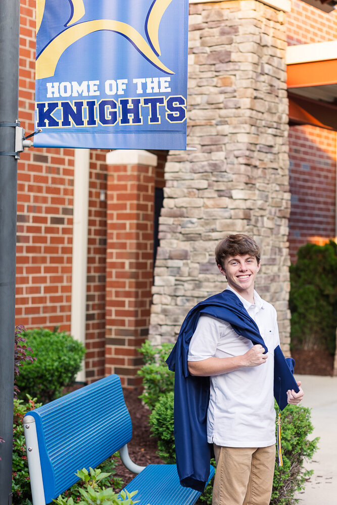Cap & Gown portrait session in NRCA with Home of the Knights background in Raleigh, NC