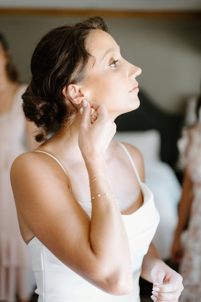 Bride preparing with jewelry.