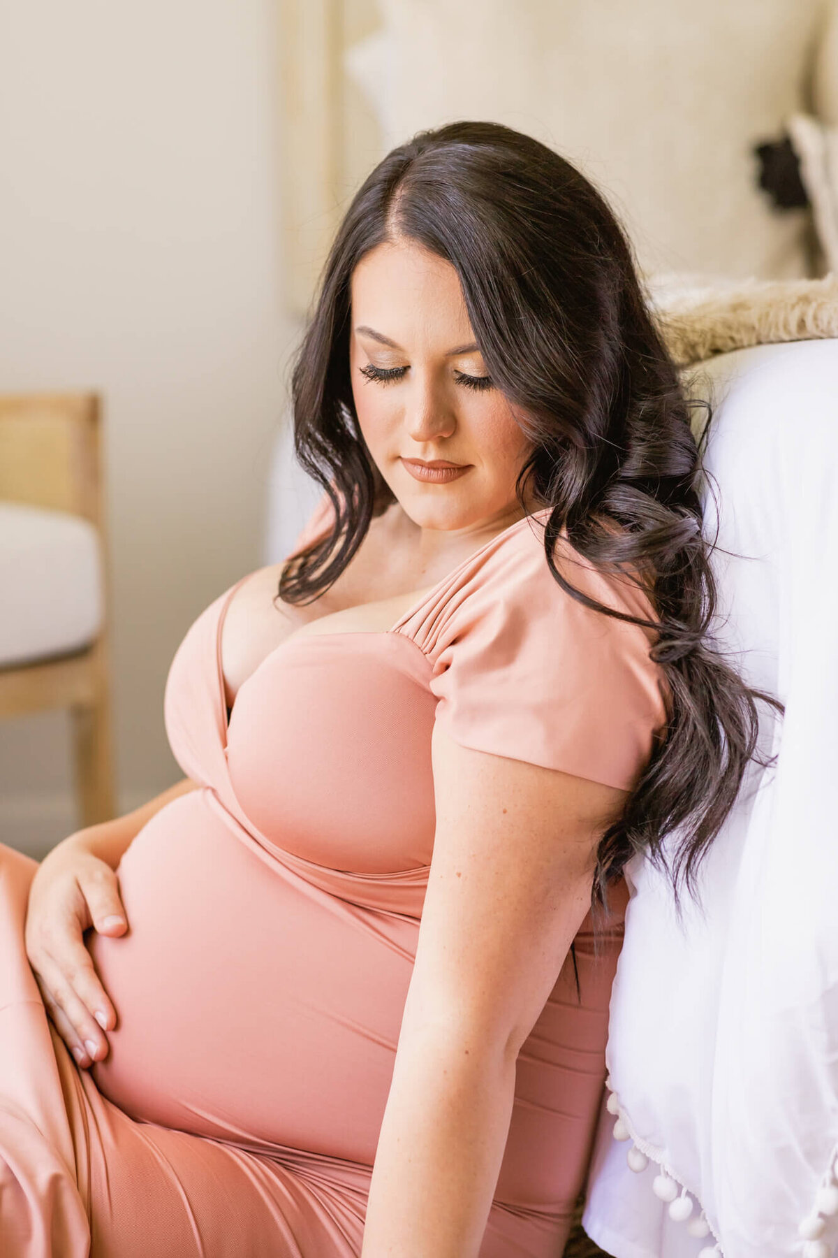 Expectant mom in a rose gold maternity dress