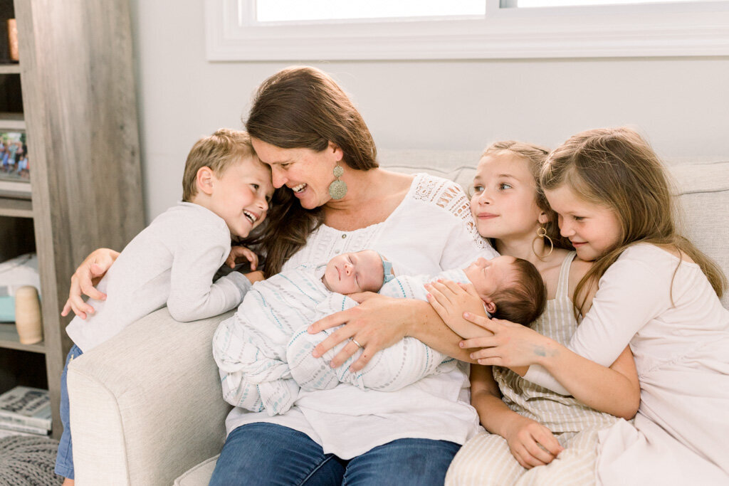 Mother snuggling five children