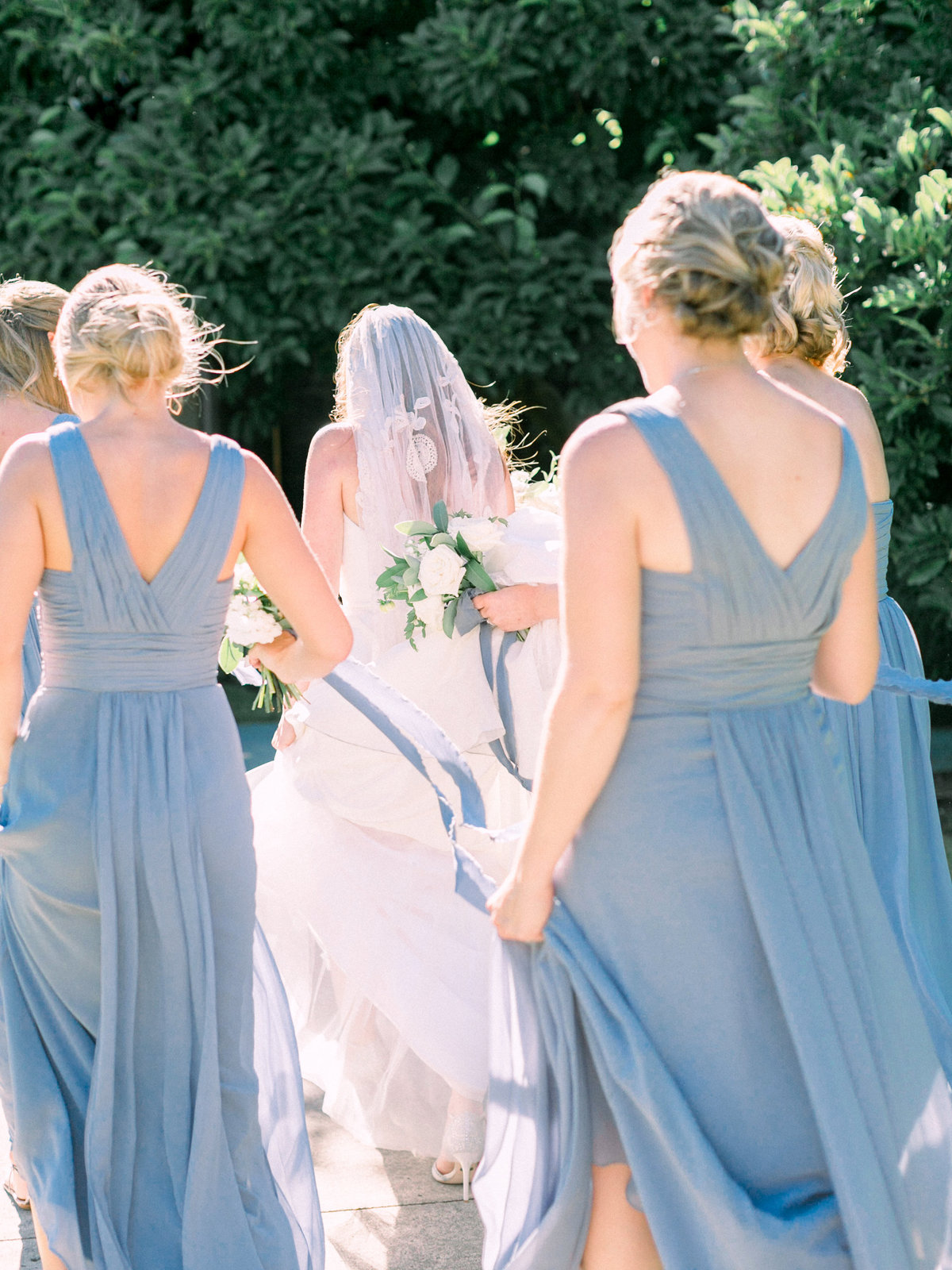 a bride walking with her bridesmaids