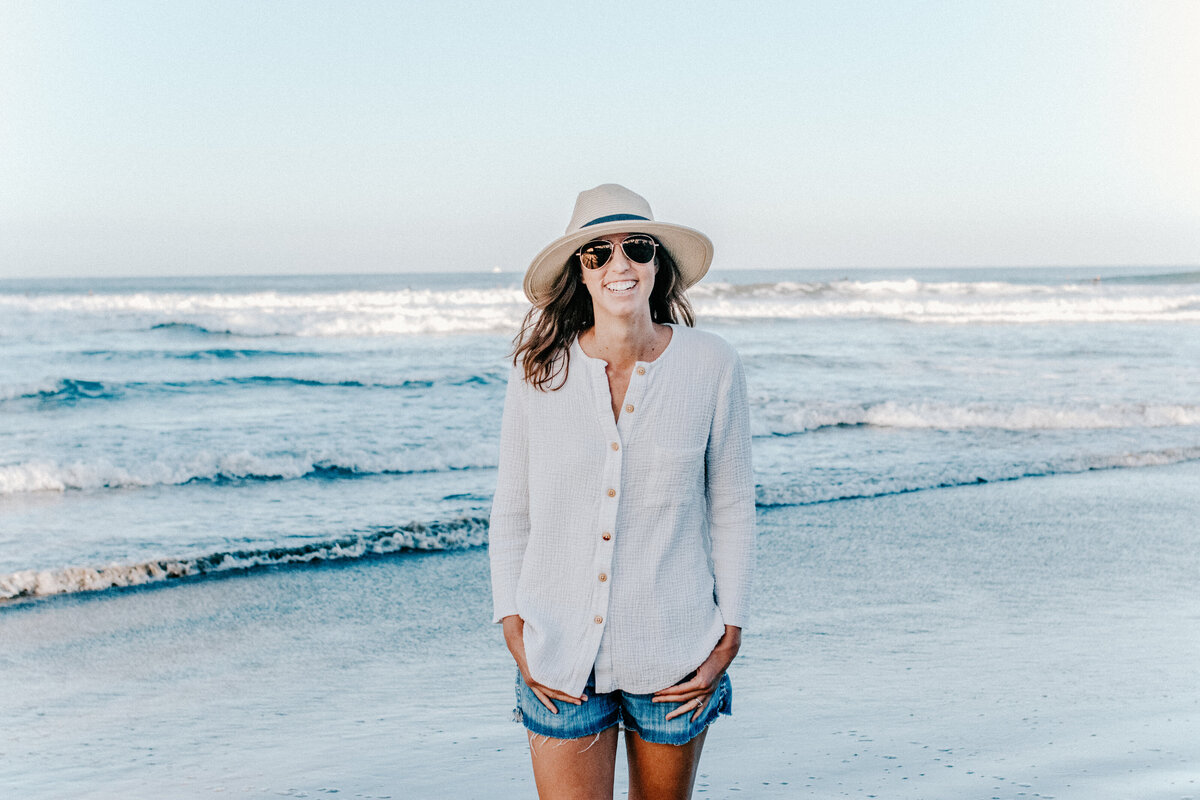 smiling  woman in hat on beach