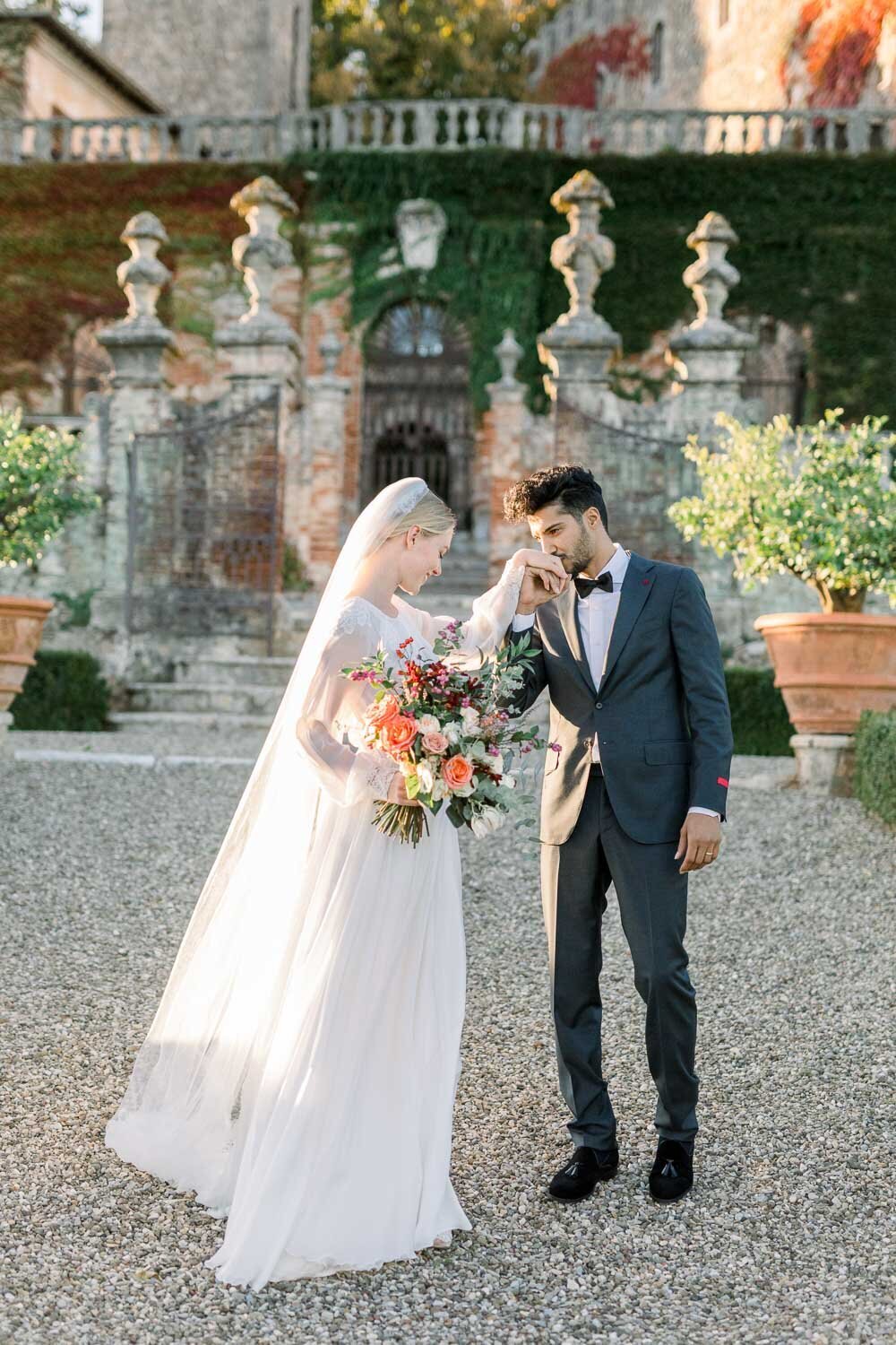 Groom kissing his bride in Tuscany
