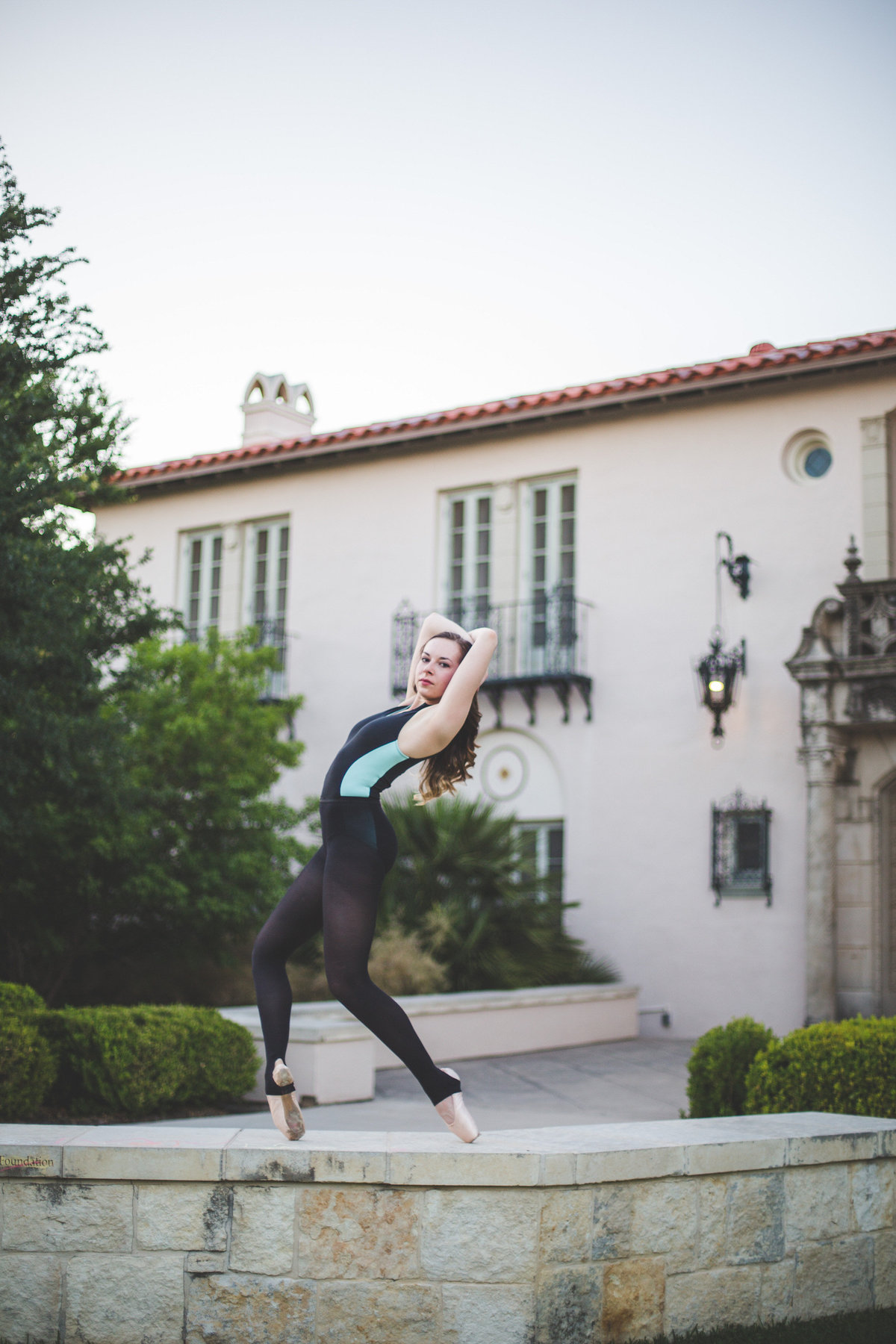 senior girl high school ballerina posing and bending back by San Antonio senior photographer
