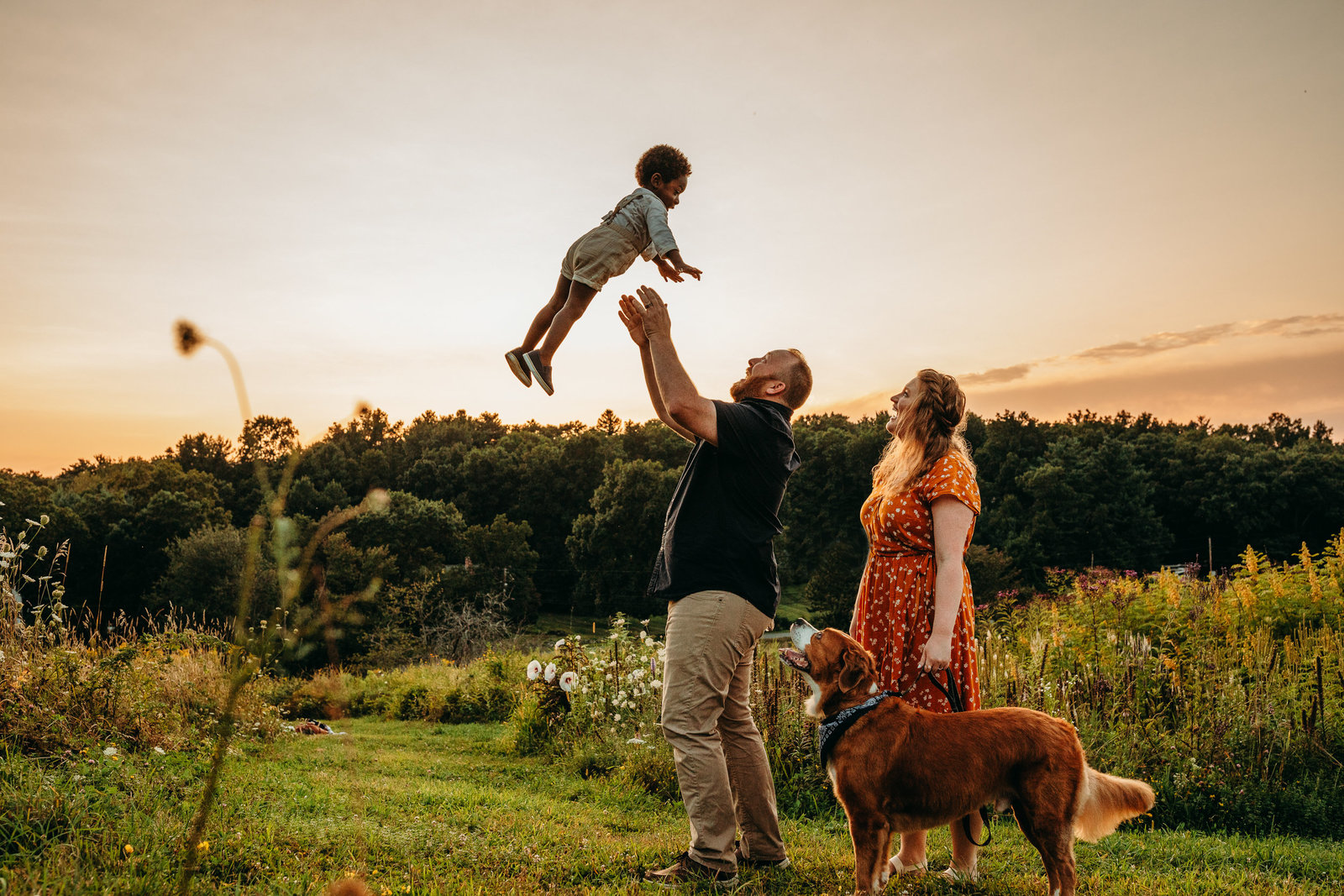 parents toss toddler boy into the air on top of a hill in southborough ma