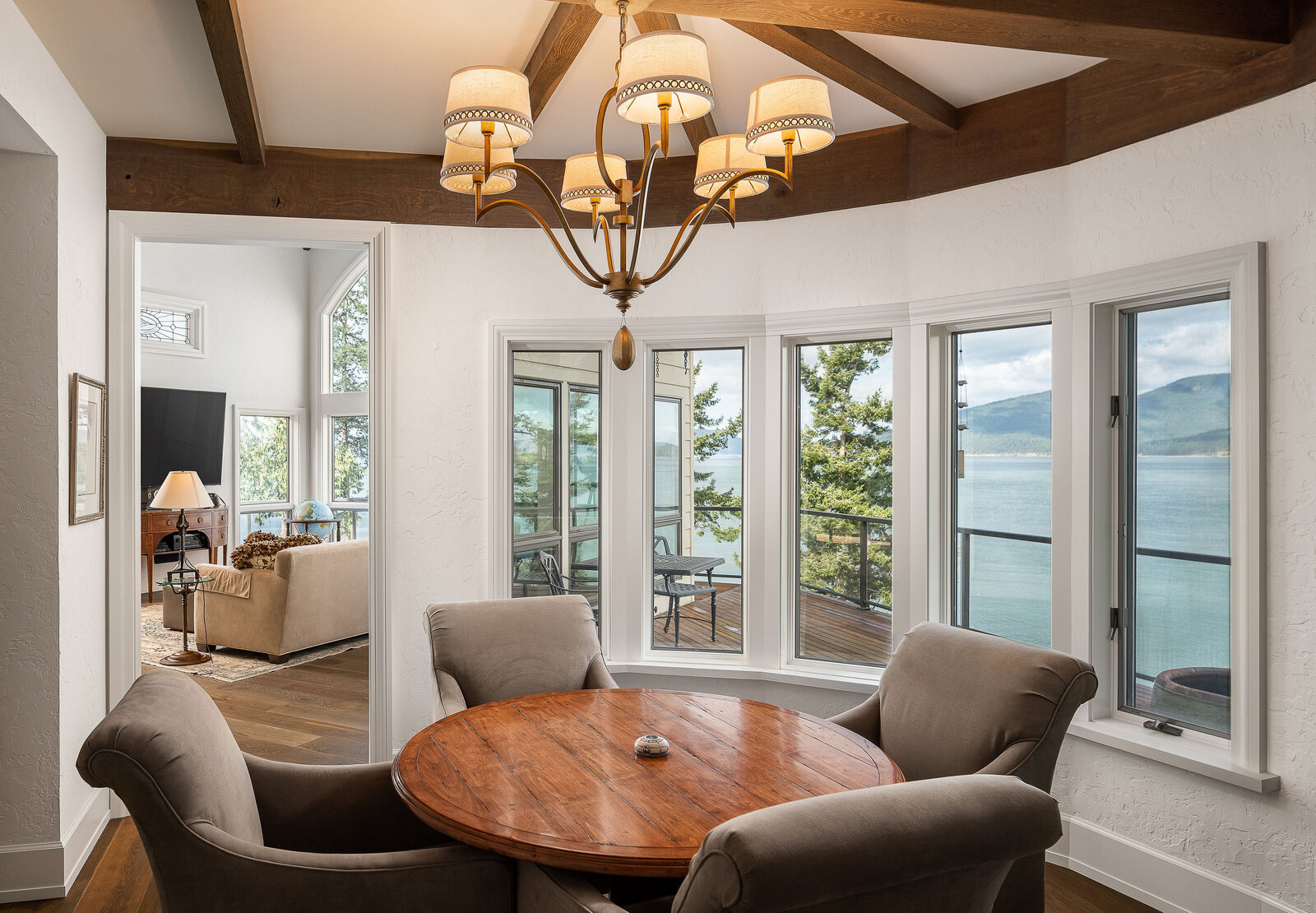 exposed beam dining room with waterfront view