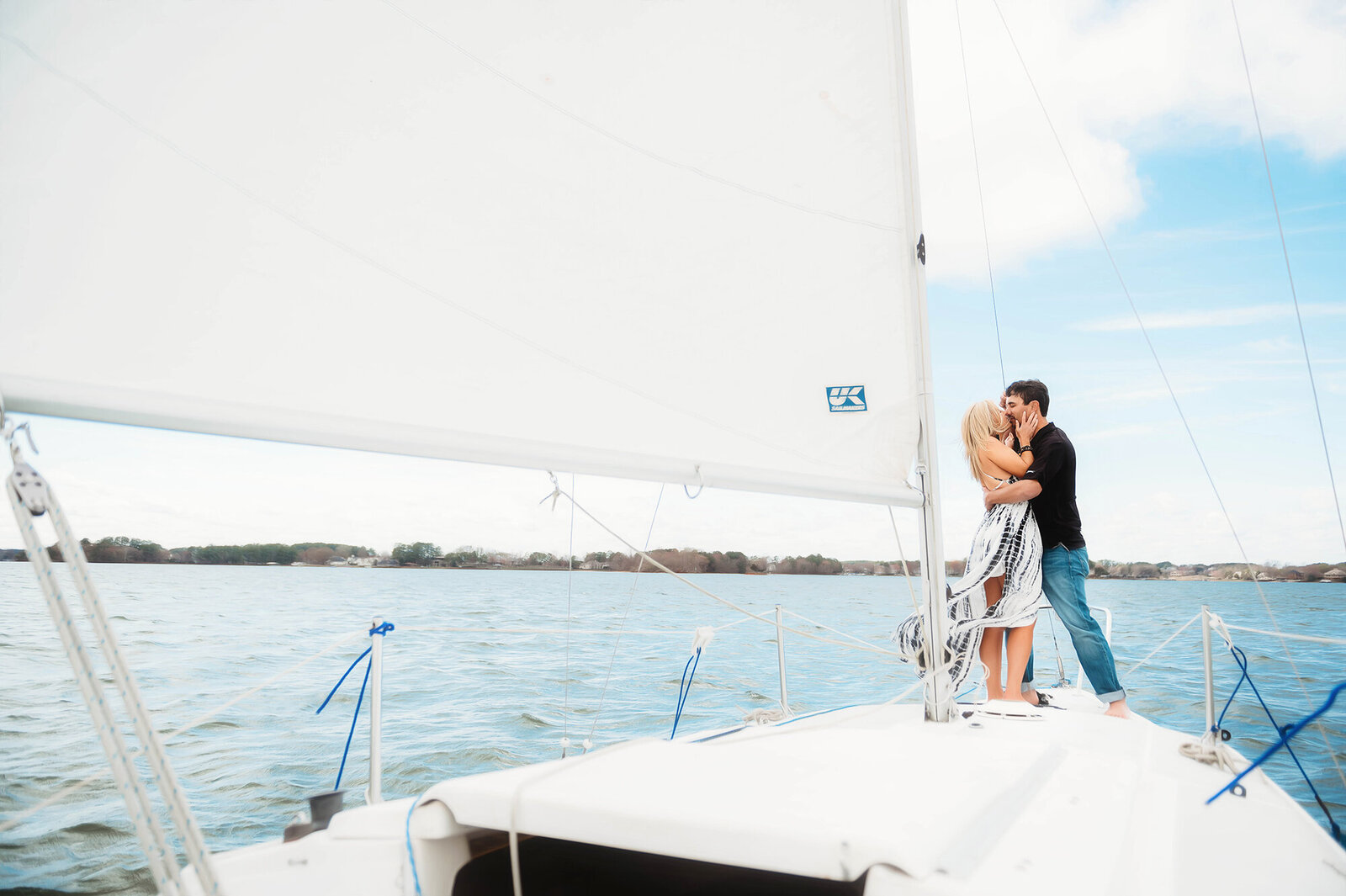 A couple poses for Engagement Photos on a Sail Boat in Asheville, North Carolina.