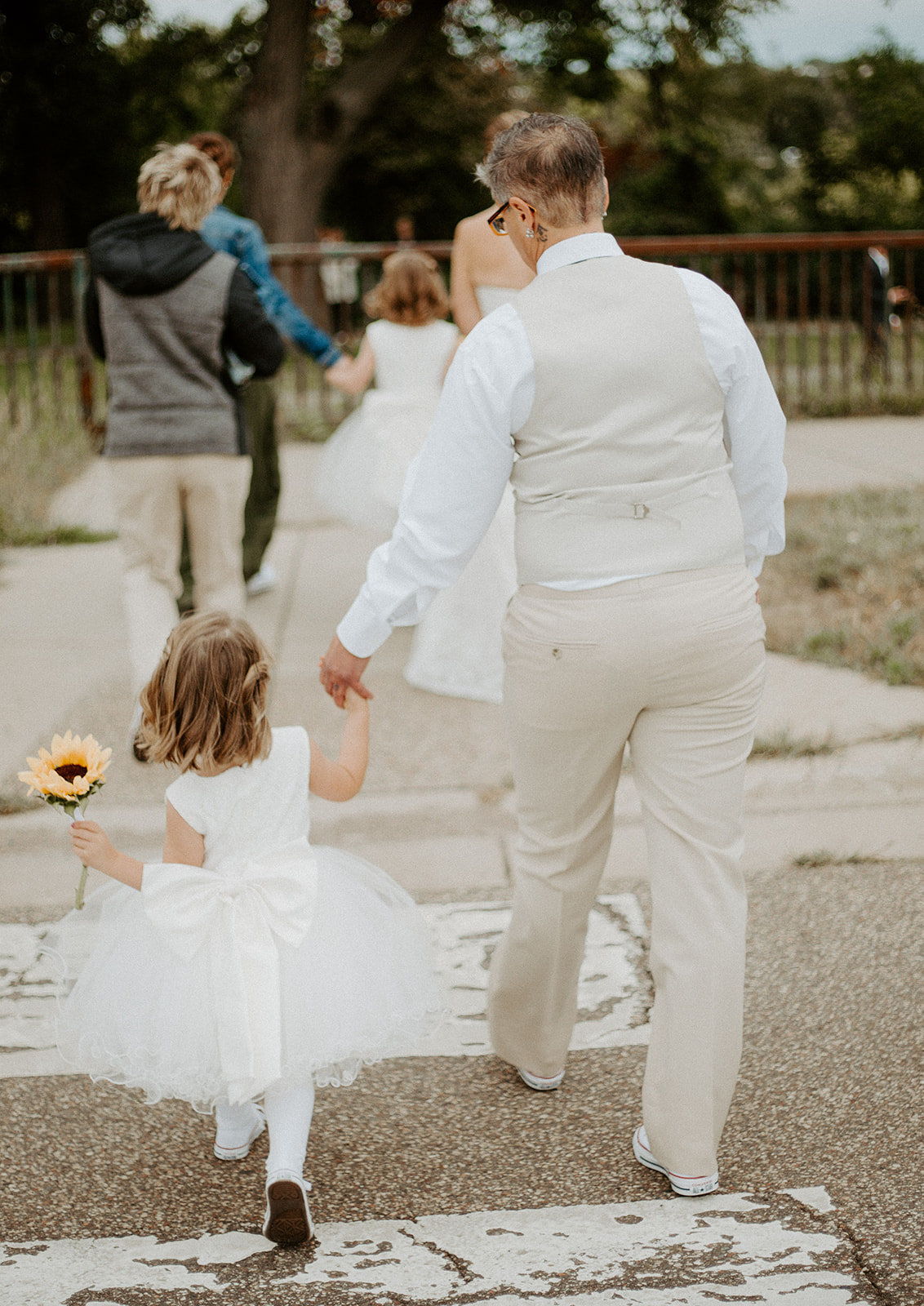 Flower girl walking across the street during a Minneapolis wedding