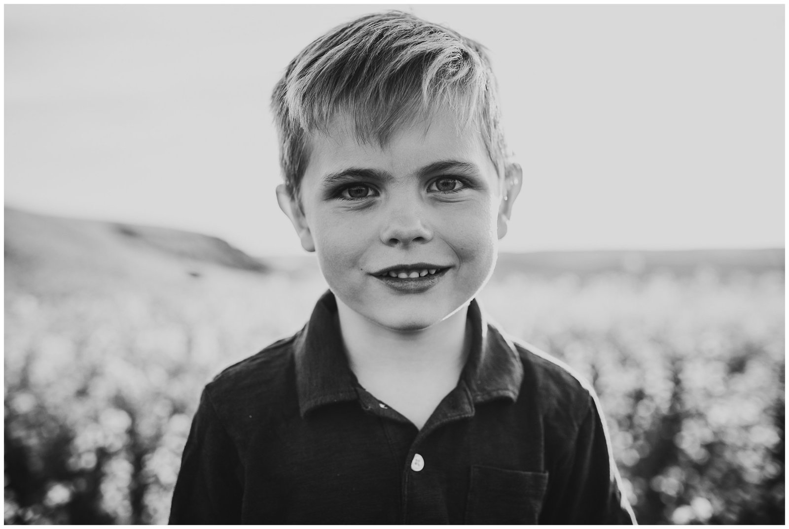 black and white image of little boy in field Emily Ann Photography Seattle Family Photographer