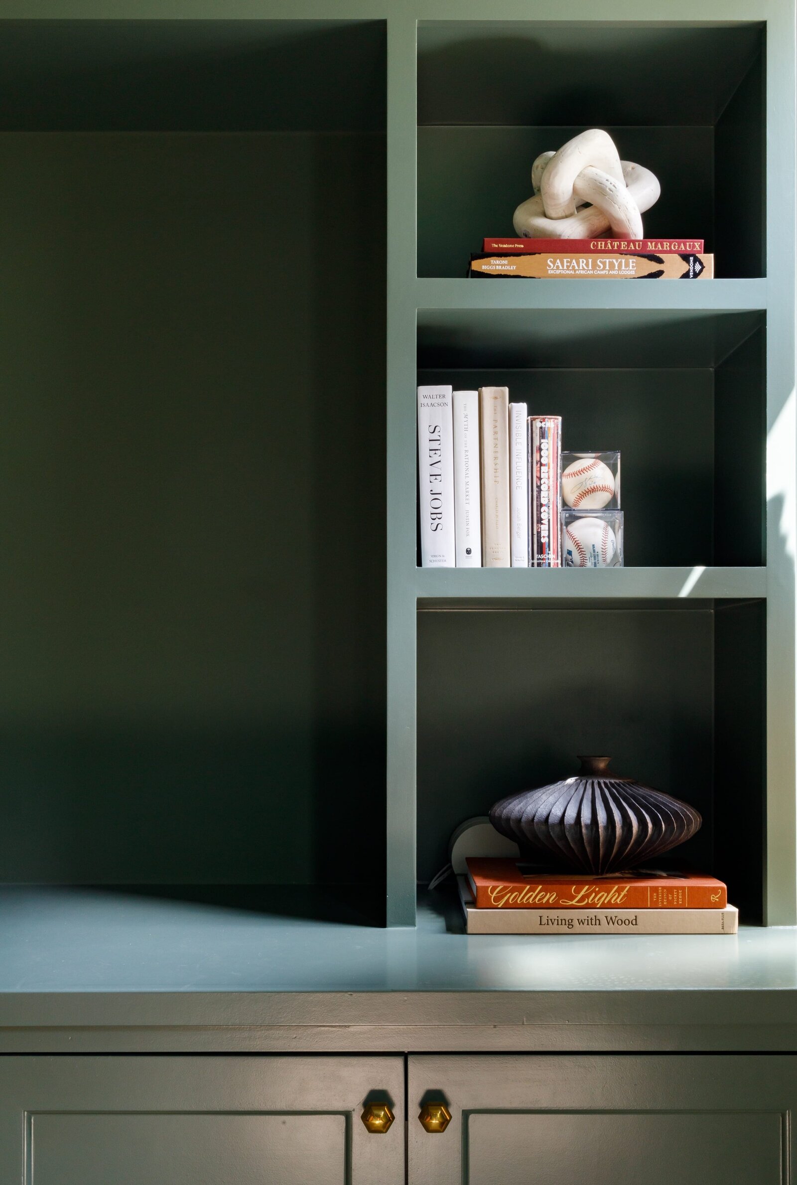 vision and hammer styling shelf with dark green painted cabinets
