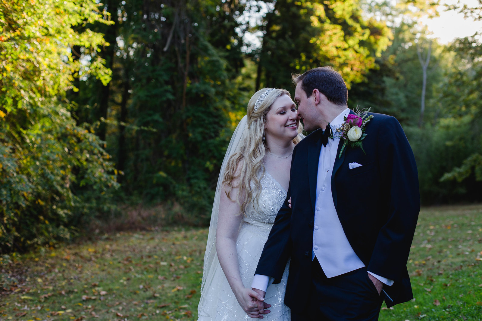 a bride and groom share a snuggle on the lawn of pittsburgh's springwood conference center