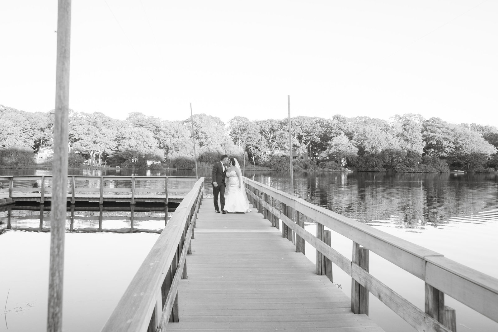 Bride and groom walking down dock at Camp Pa-Qua-Tuck