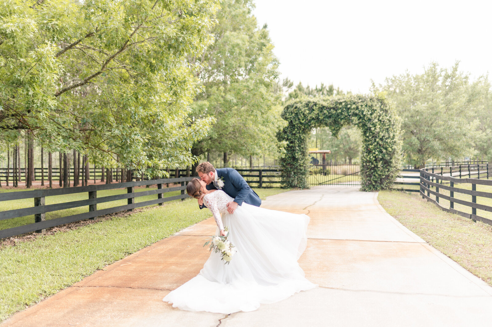 Bride and Groom dipping and kissing at Club Lake Wedding venue in Apopka florida