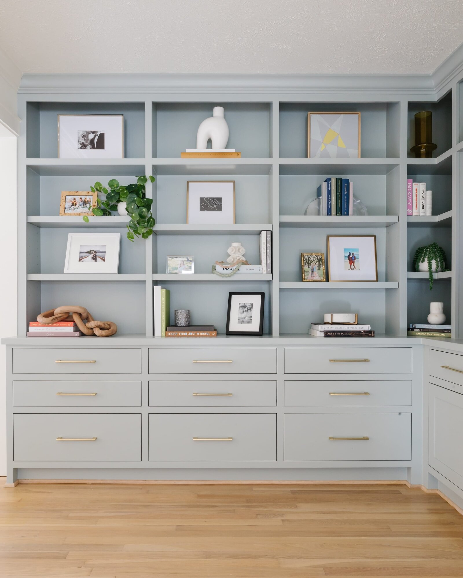 vision and hammer styling shelf with blue paint and picture frames