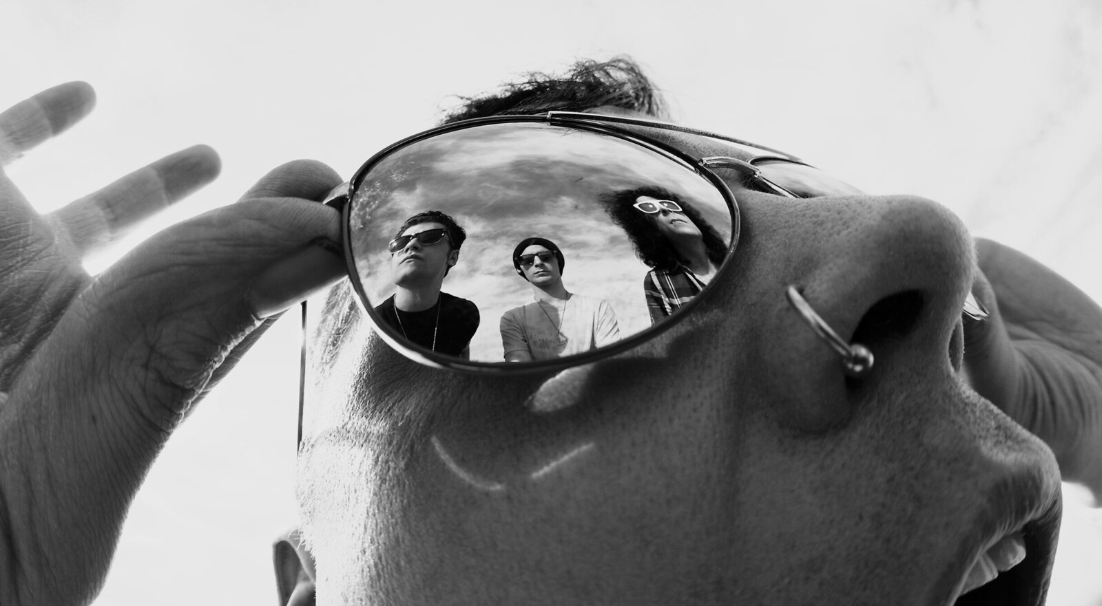 Musician Portrait lead singer band Faber Drive in closeup black and white reflection of band members in his sunglasses