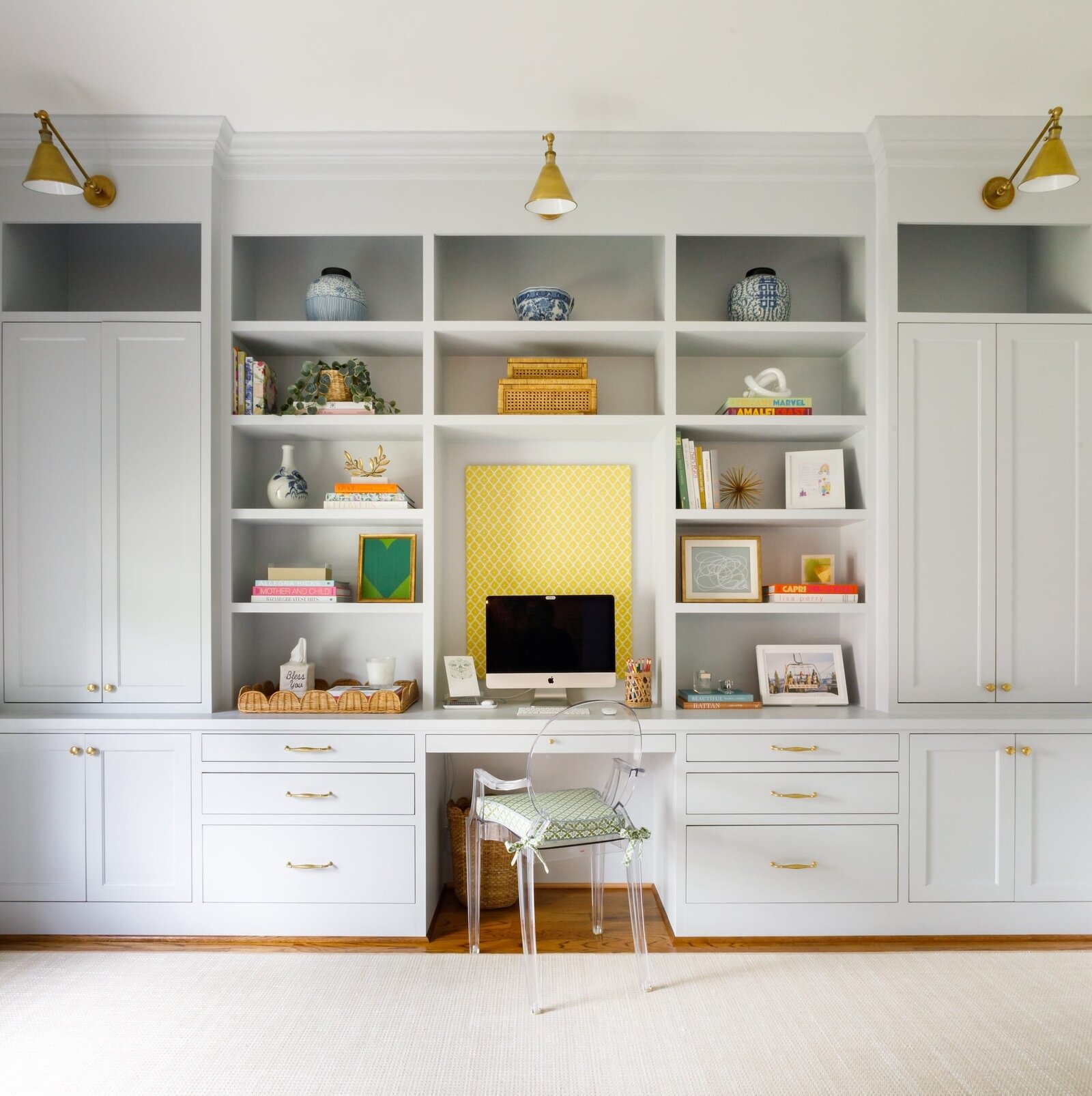 vision and hammer white buildins with gold lamps and office chair and computer