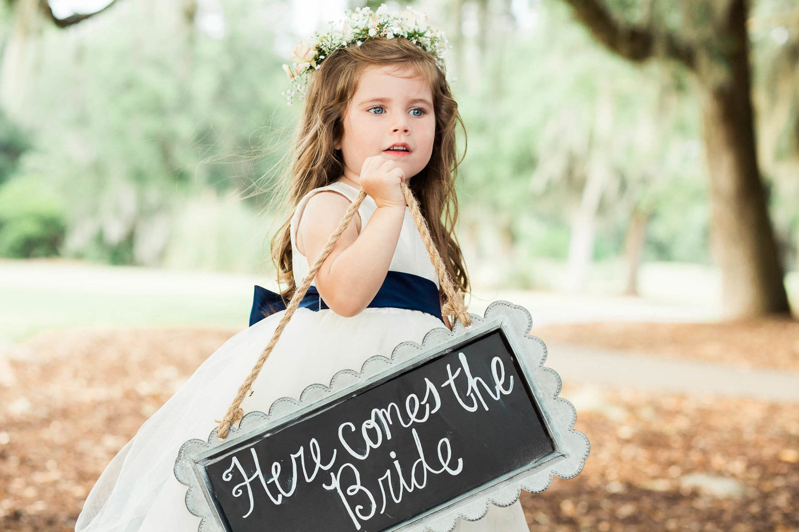 Flower girl walks down the aisle, Dunes West Golf and River Club, Mt Pleasant, South Carolina. Kate Timbers Photography.