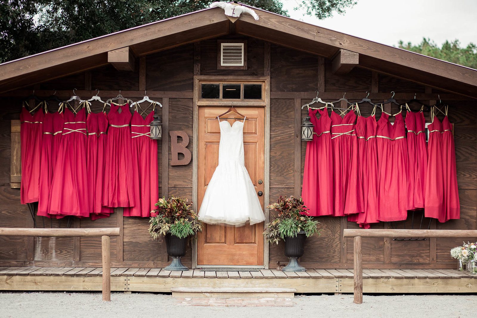 Wedding and bridesmaid dresses are hung in cabin, Boals Farm, Charleston, South Carolina