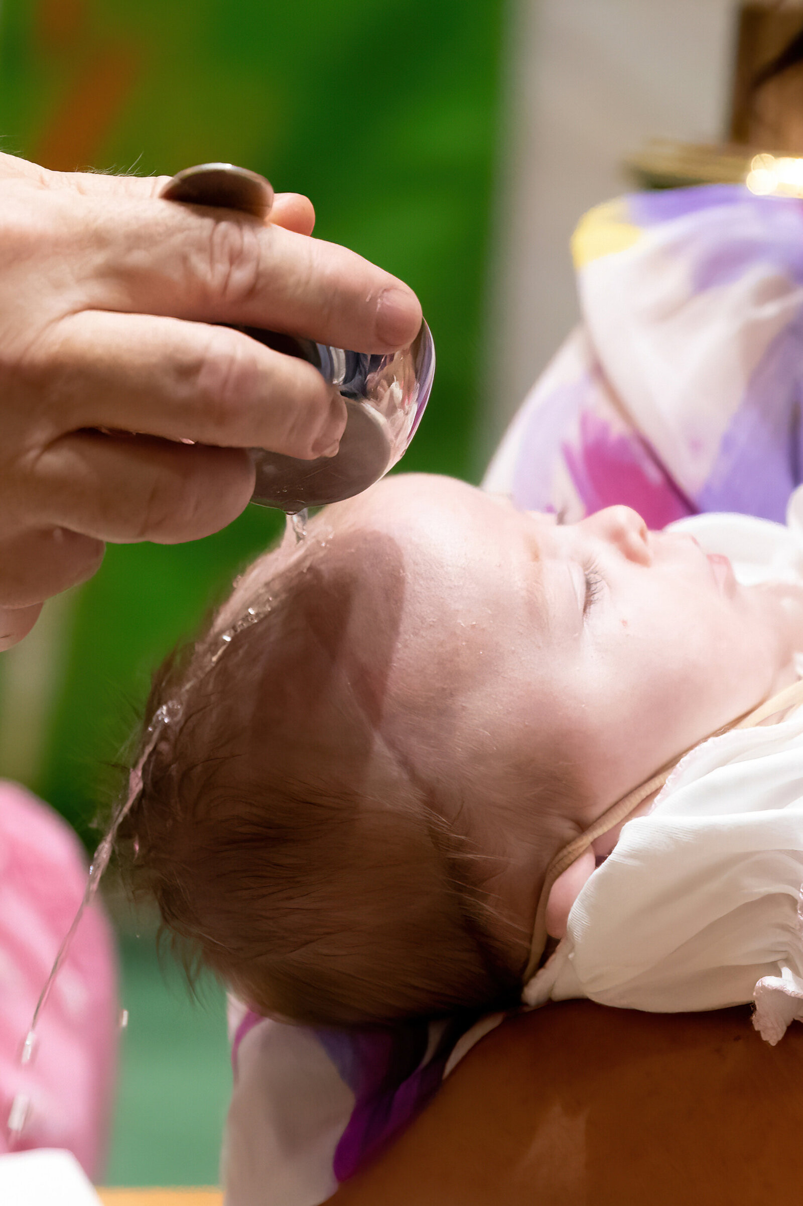 Closeup of holy water poured on baby's head Saint Augustine New City Rockland County baptism photographer Milestone Images