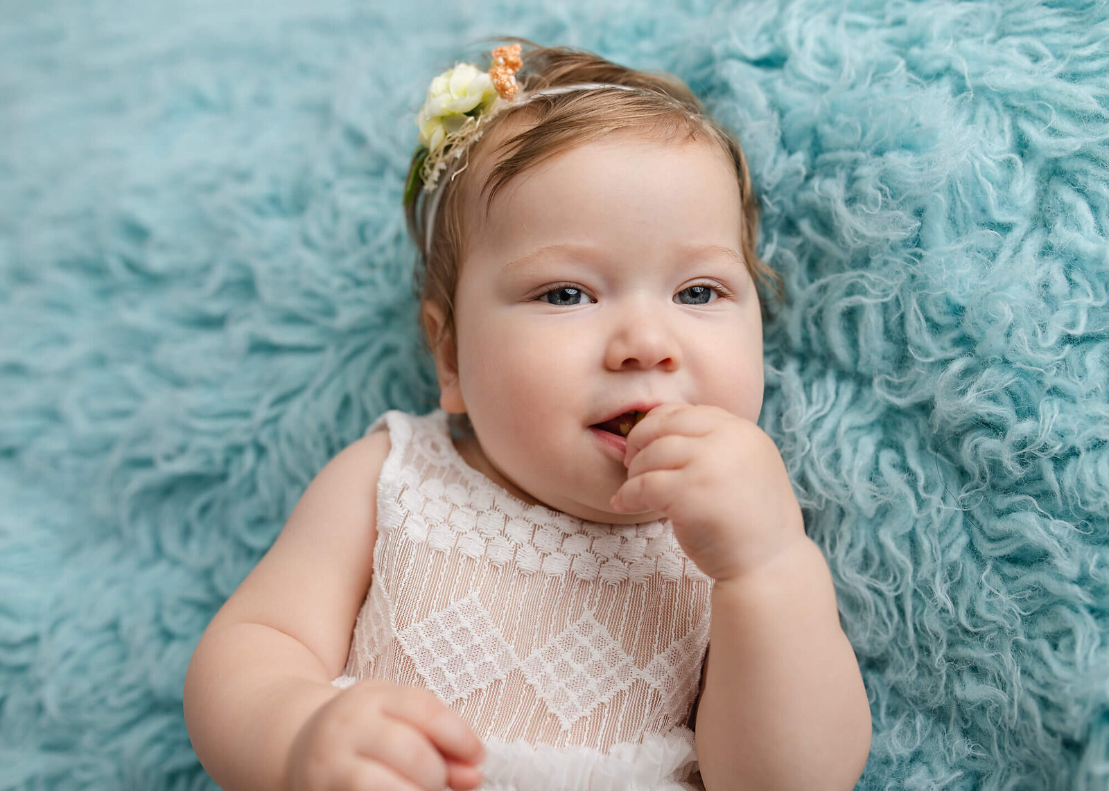 baby girl on blue flokati, Moline baby photographer, baby photos Moline, Moline newborn photography