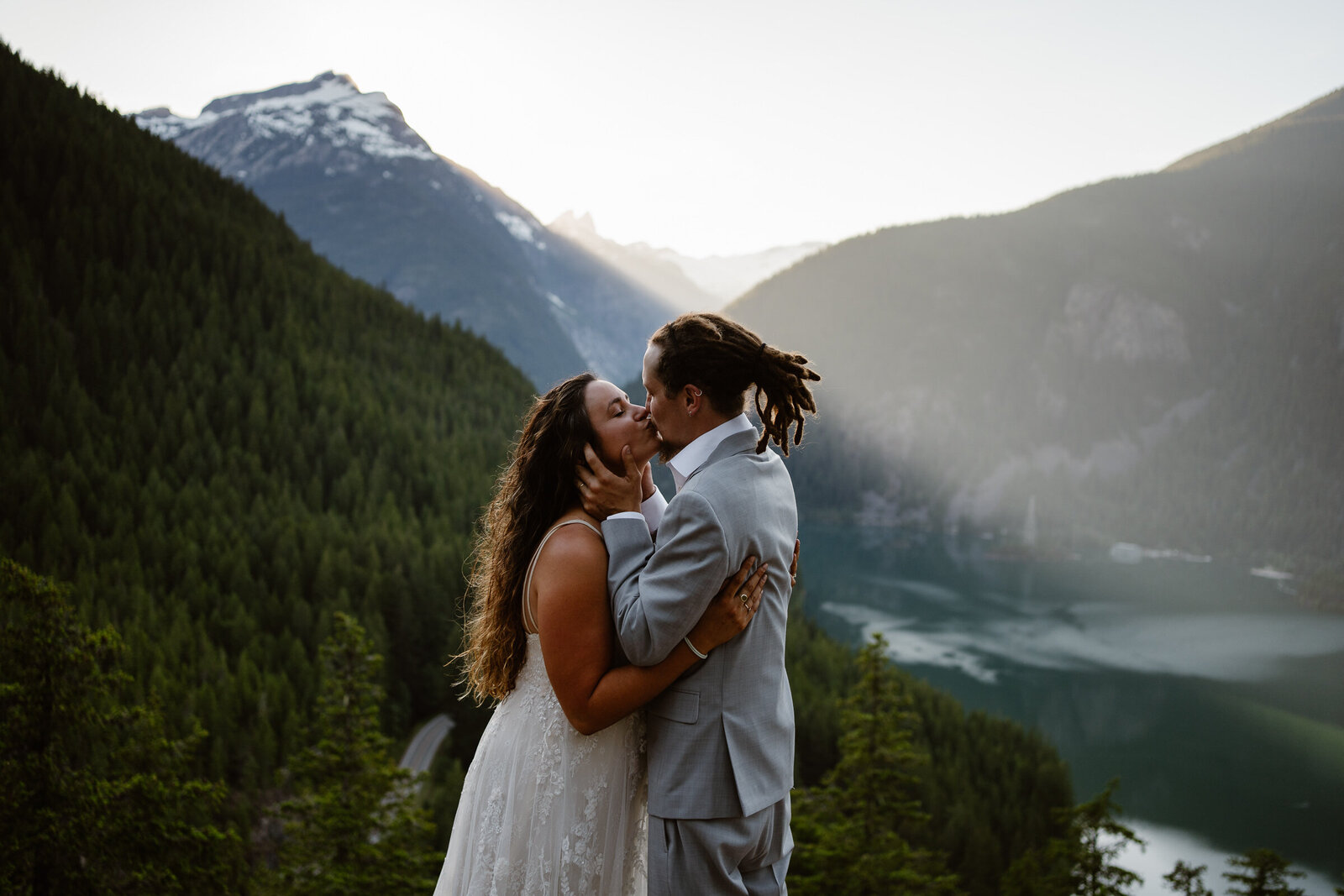 a bride and couple have their first kiss at diablo lake for their Washington elopement
