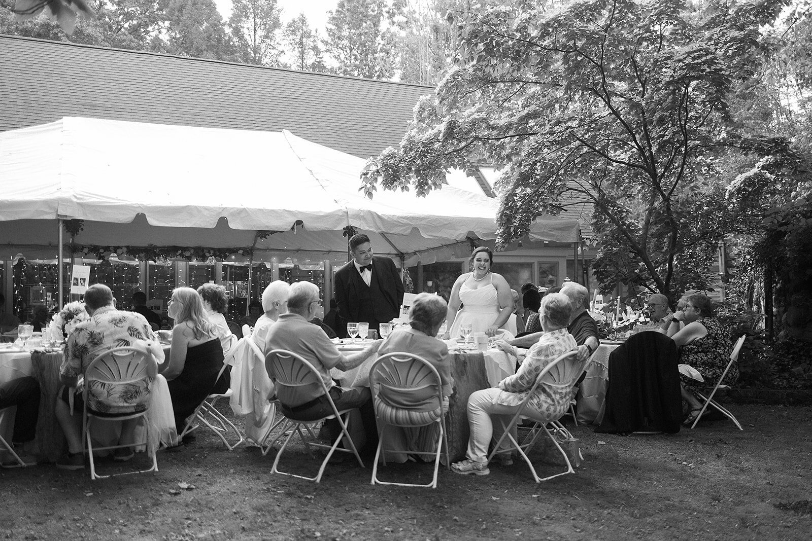 Groom hugging a friend after northern michigan wedding ceremony