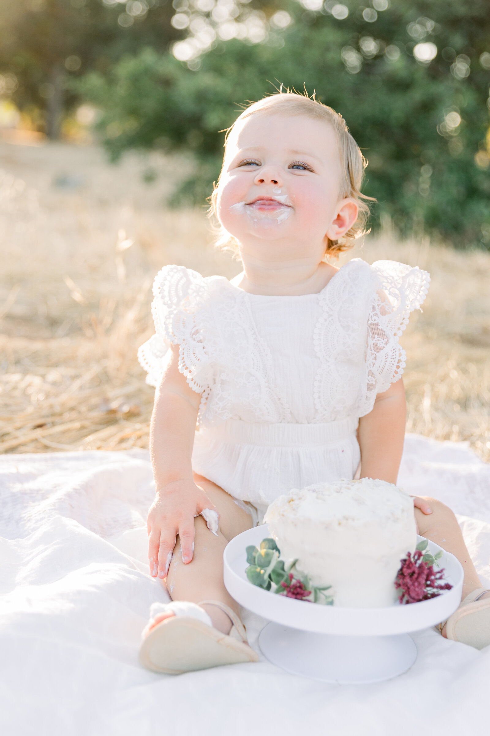 Image of one year old baby and cake smash taken by Sacramento Newborn Photographer Kelsey Krall