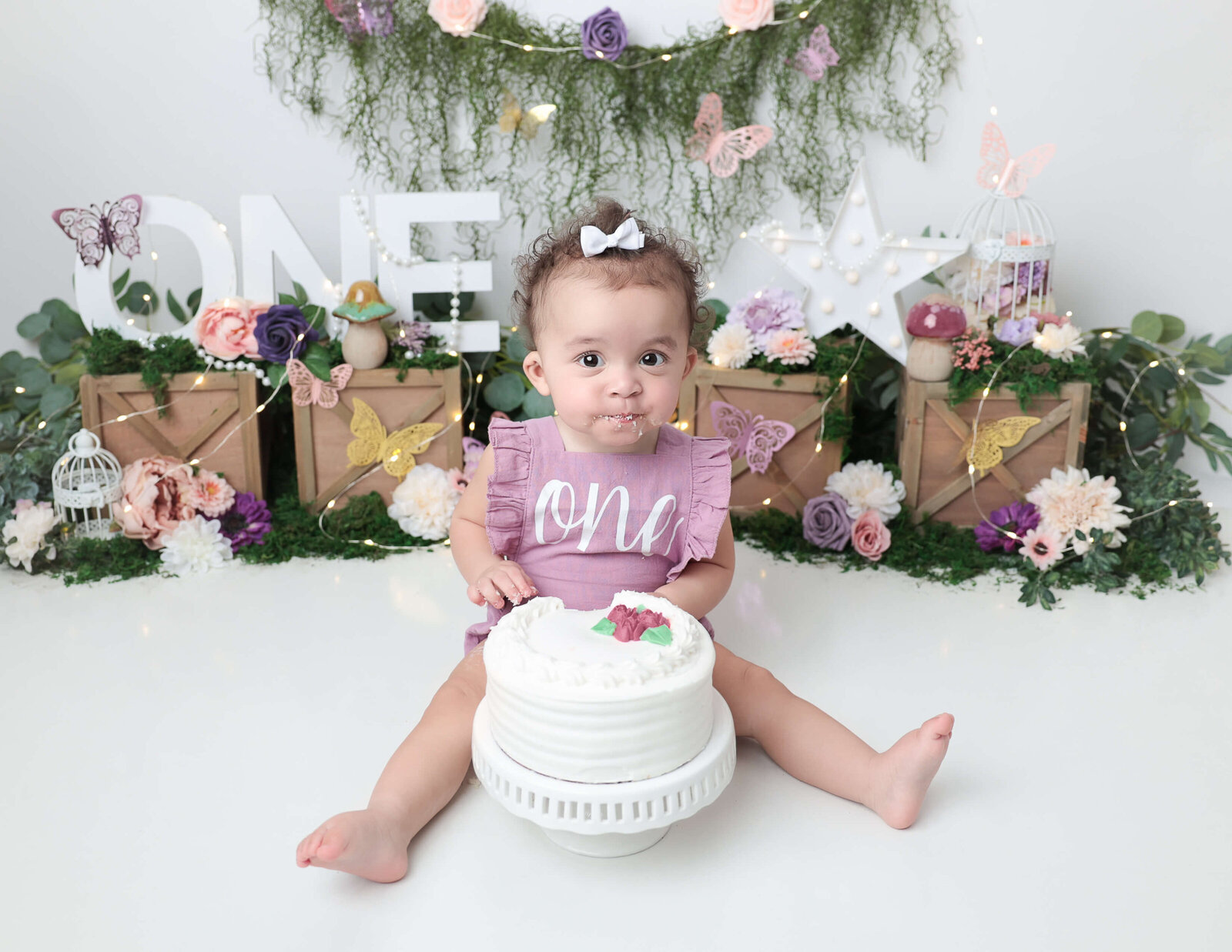 One year old with her cake at our studio.
