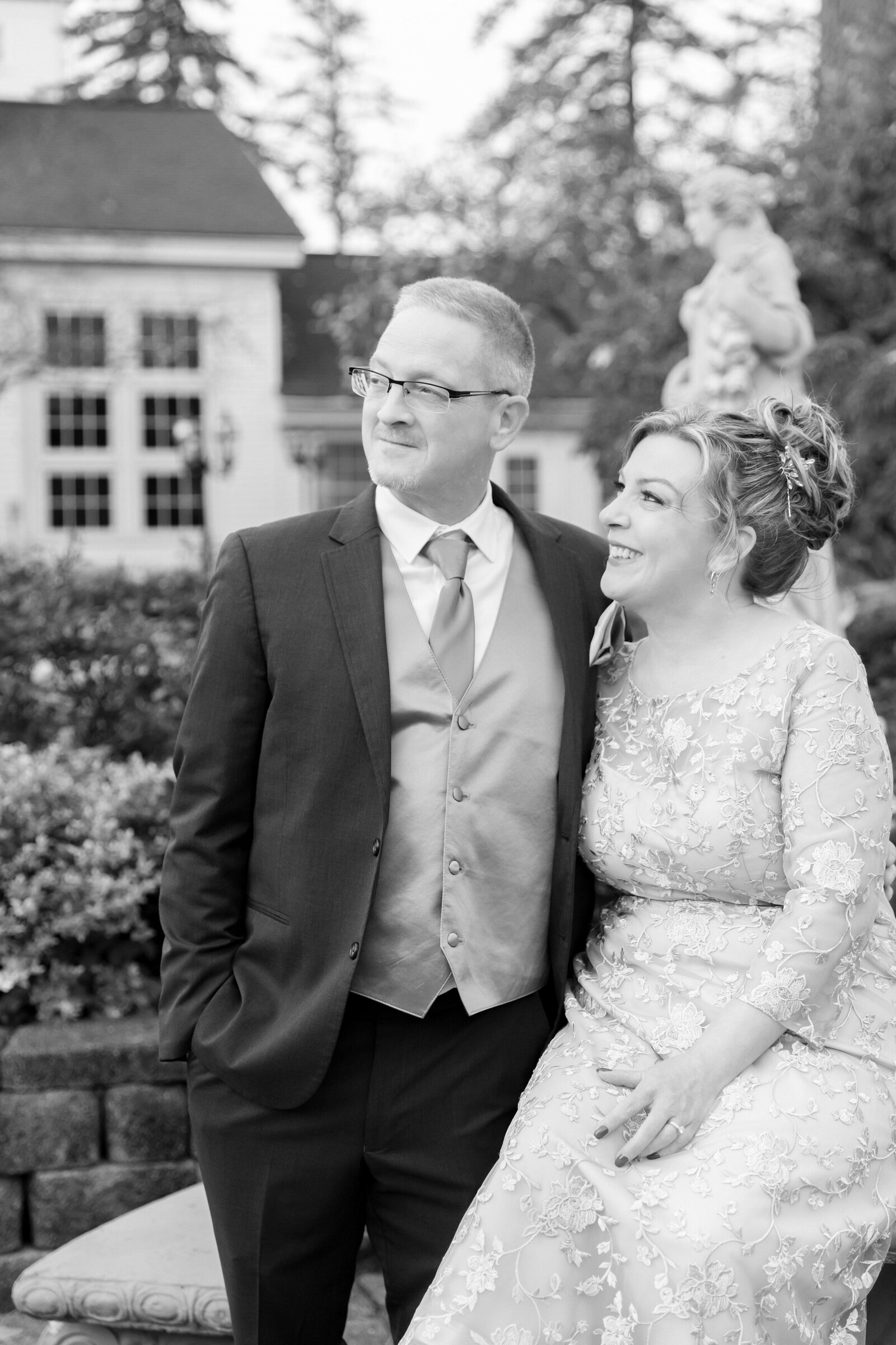 black and white photo of just married couple with wife looking at husband and smiling