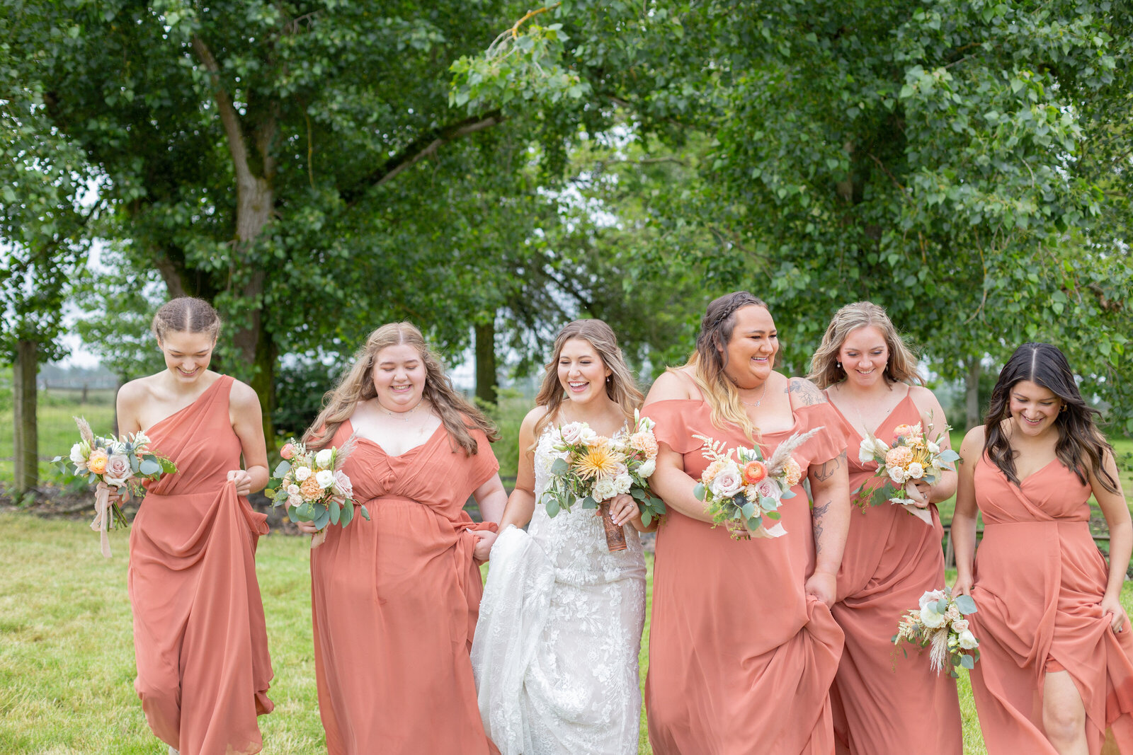 Washington Elopement Photographer captures bride walking with bridesmaids after PNW wedding