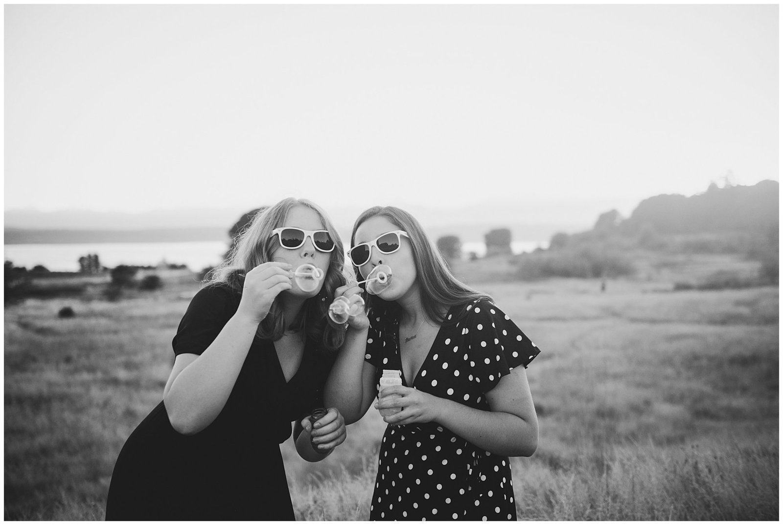 Two senior girlfriends Graduation photos blowing bubbles Emily Ann Photography Seattle Photographer