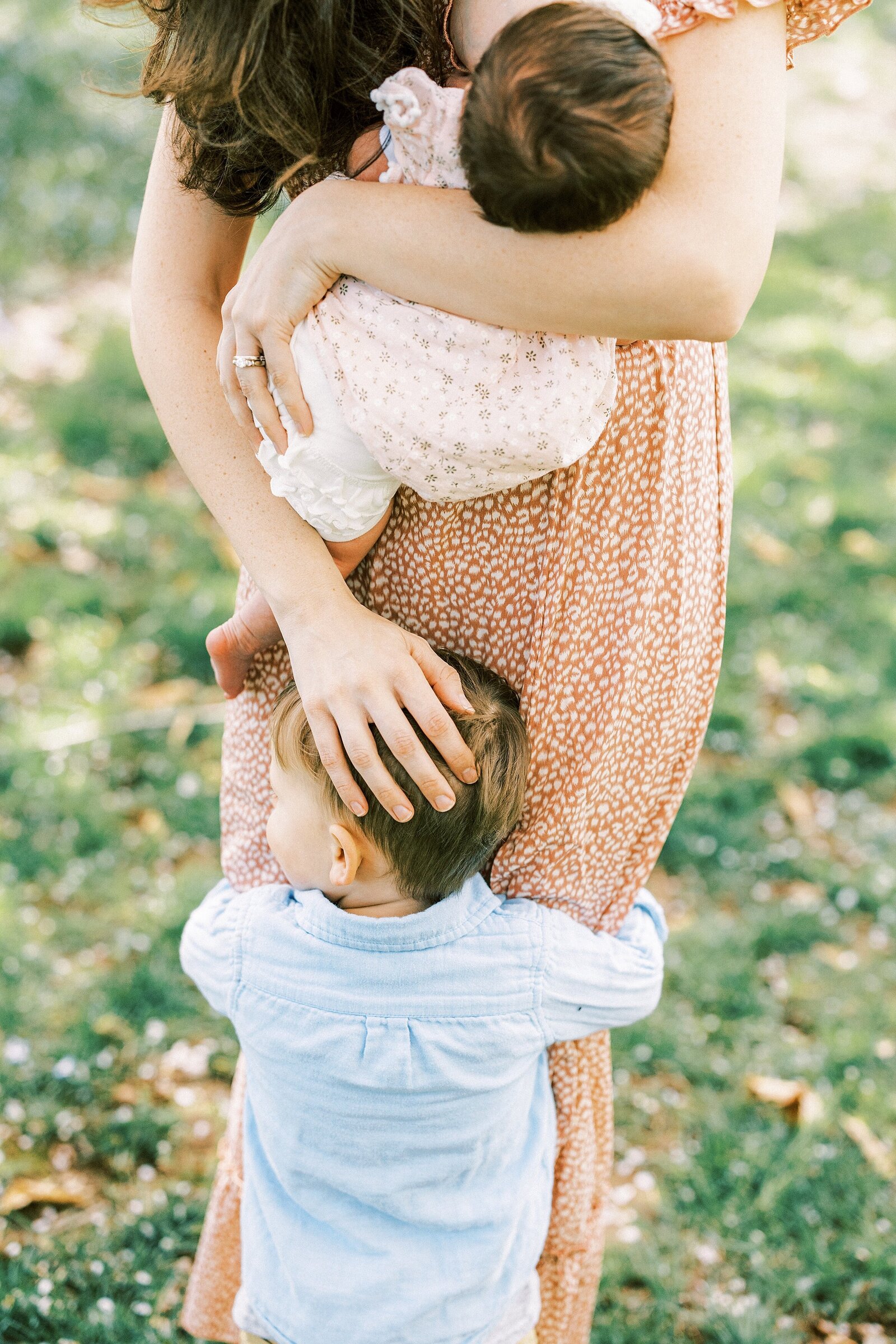 little boy hugging moms legs by Philadelphia Family Photographer