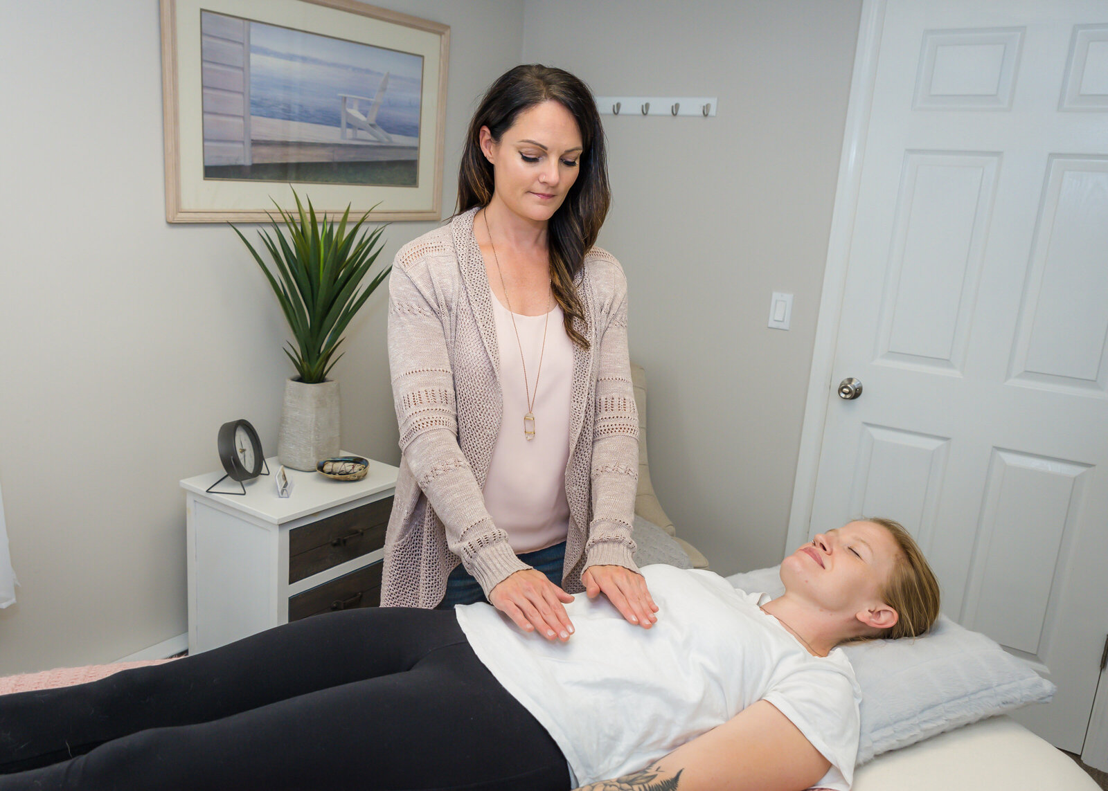 Woman giving healing energy reiki to a client