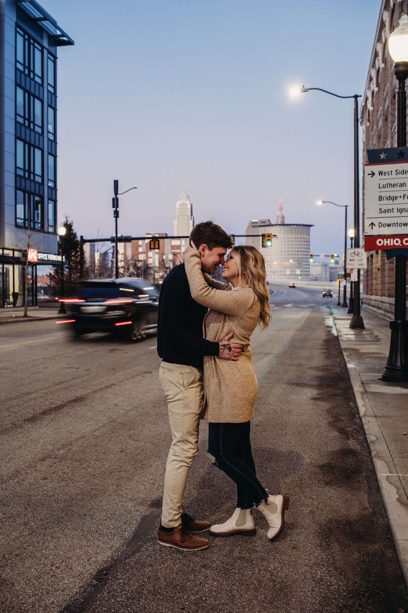 Couple pose in downtown Cleveland at dusk for their photo session.