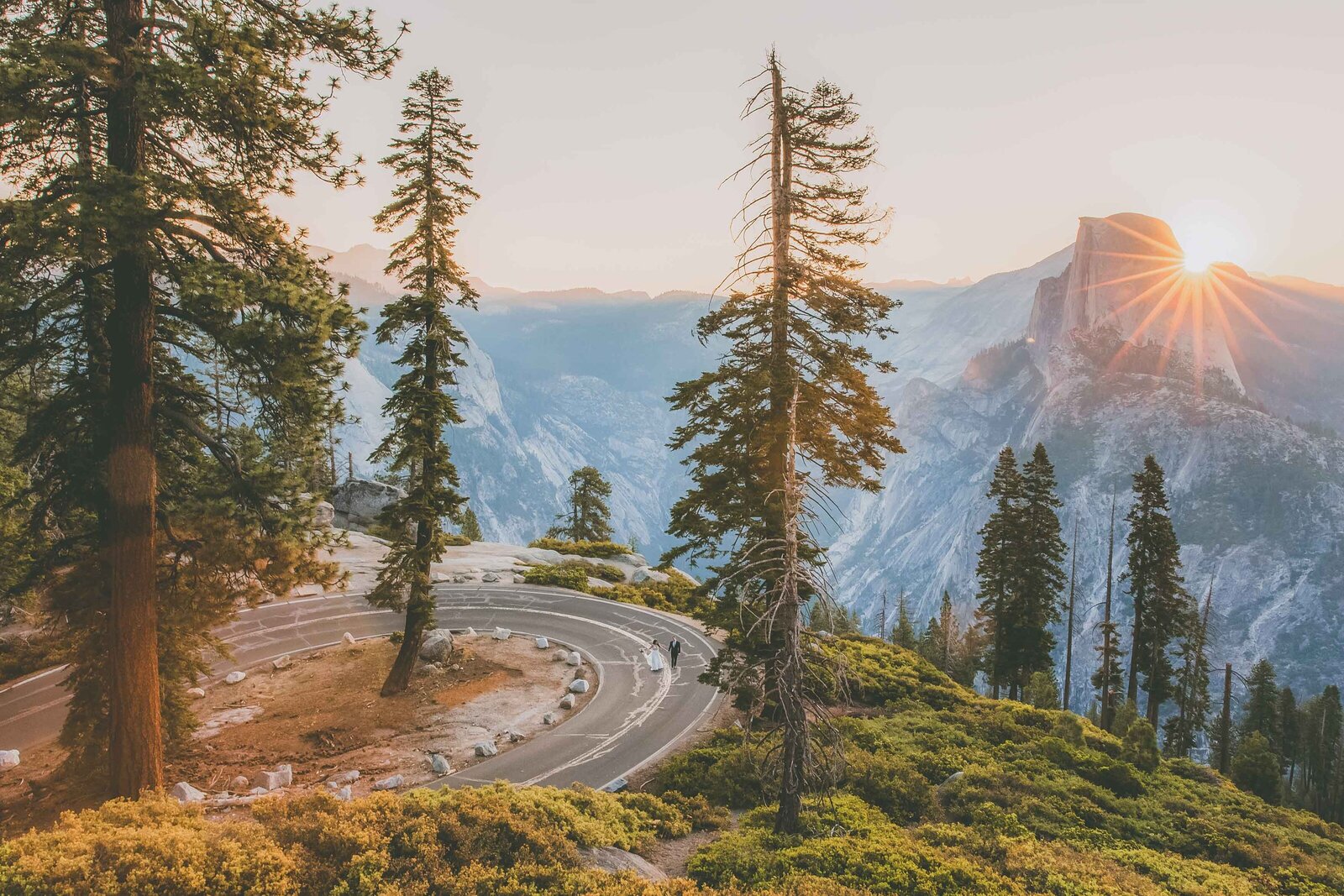 A couple walks down Glacier Point Road in Yosemite National Park.