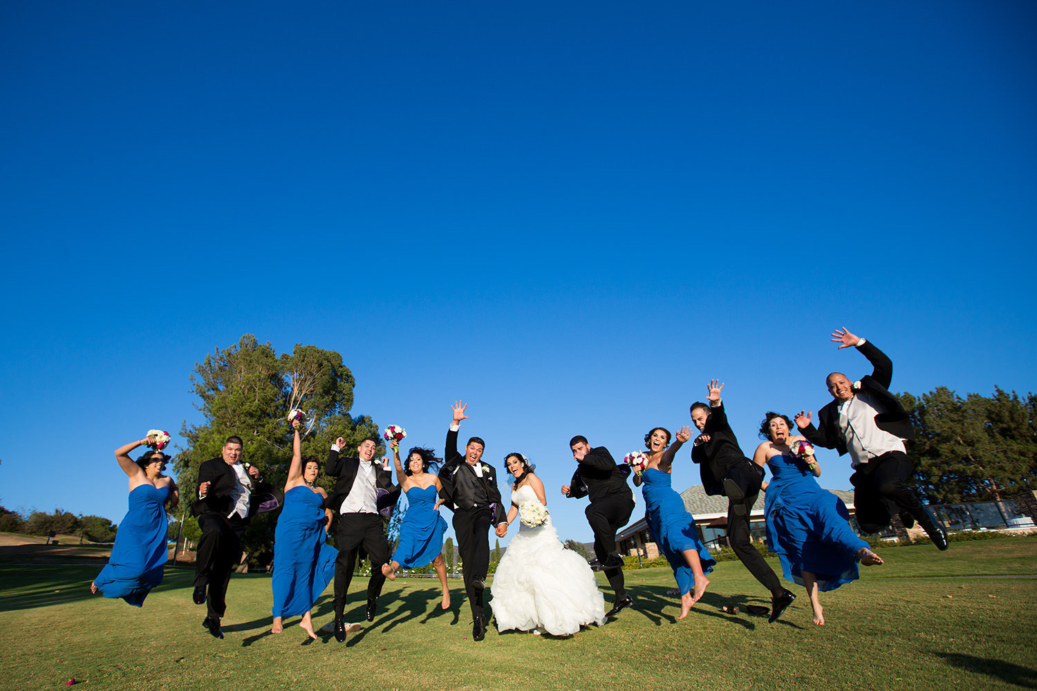 bridal party jumping in the air