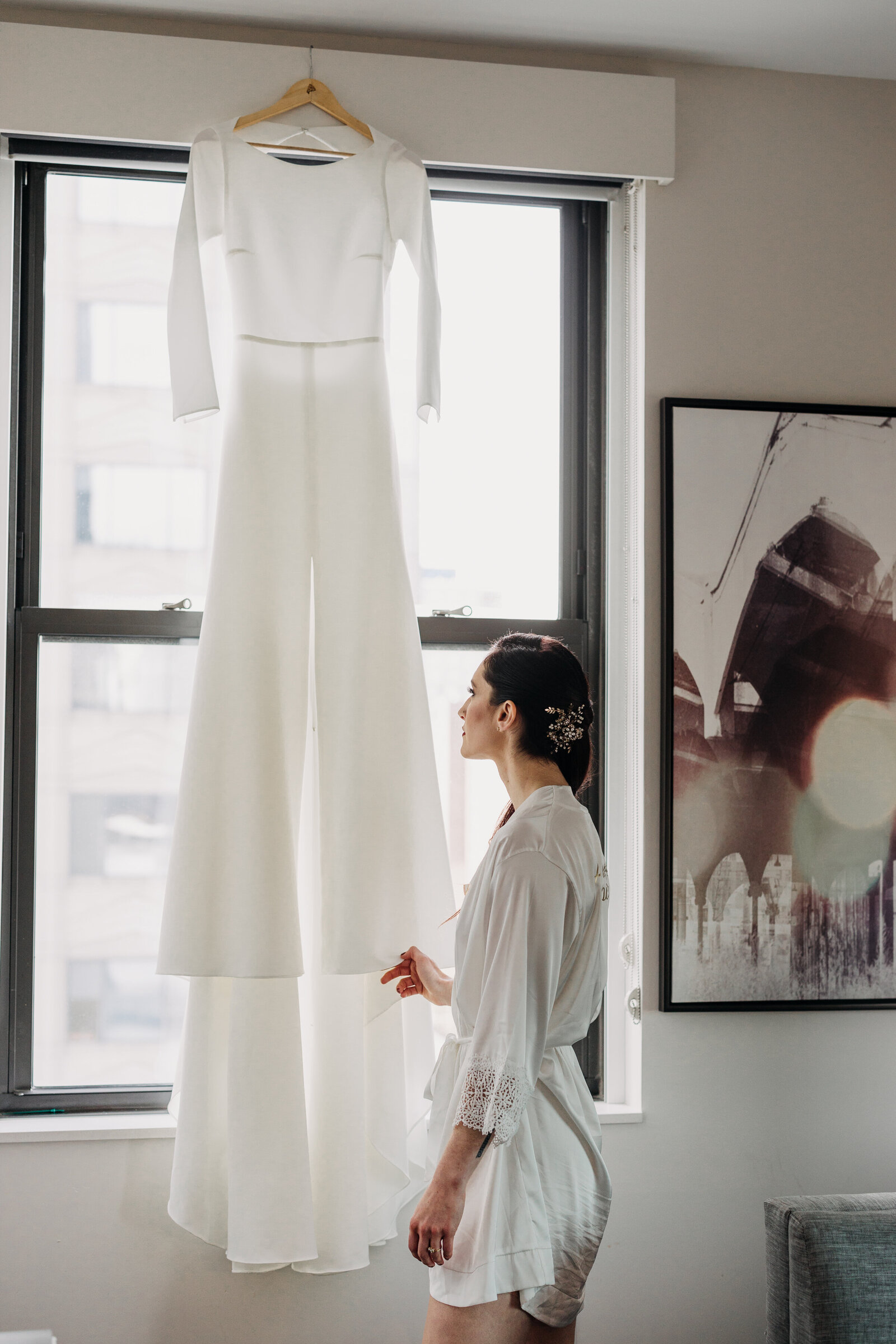 bride looking at wedding modern dress in window