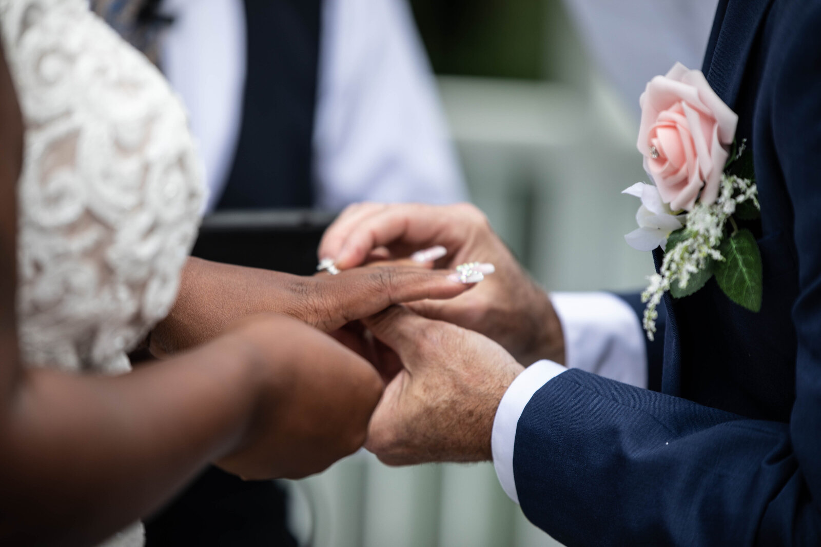 Groom-putting-wedding-ring-on-bride-finger