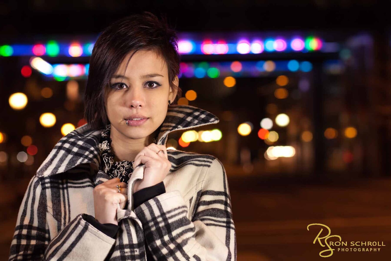 Senior photo shoot in uptown Charlotte with bokeh lights in background with Ron Schroll Photography in Charlotte, NC