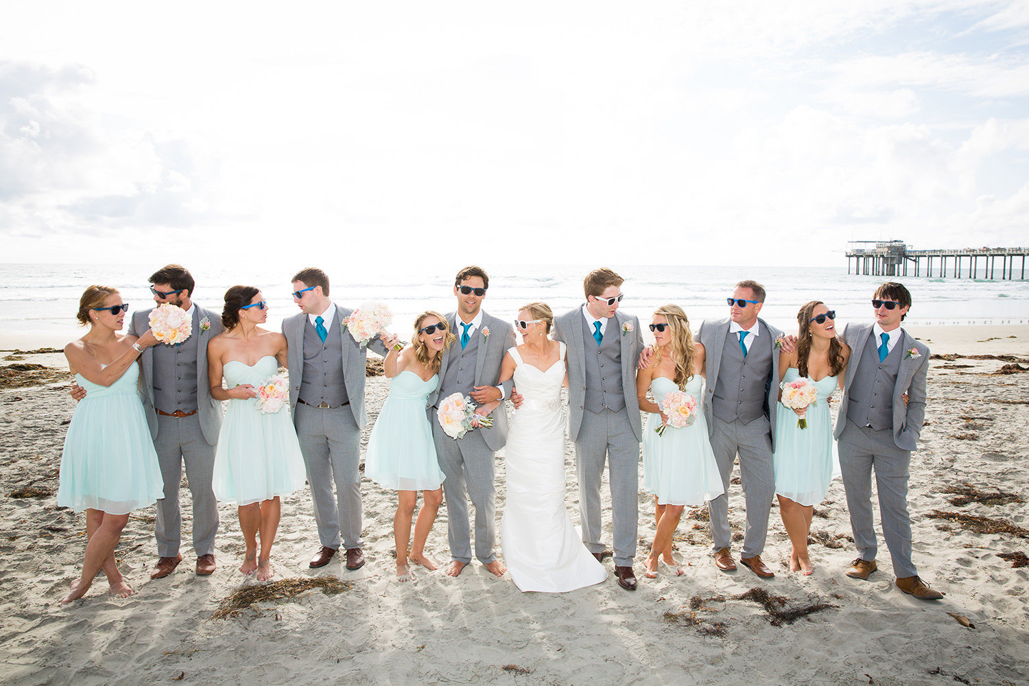 wedding party walking on the beach