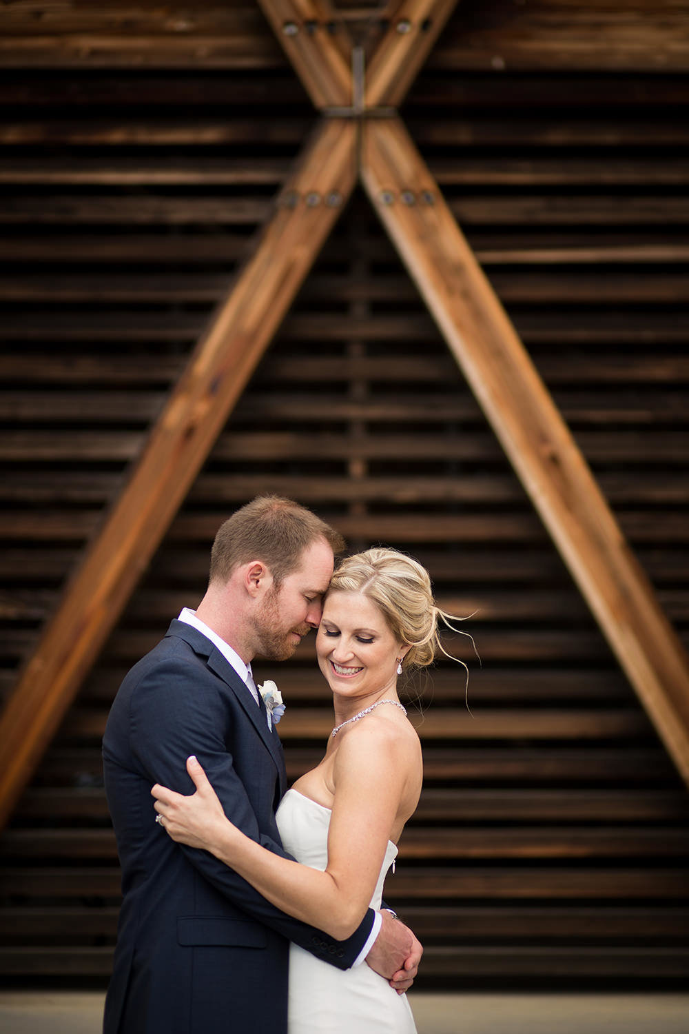 bride and groom with cool wood wall at martin johnson house