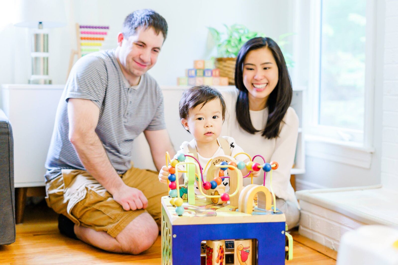 New England area family with baby playing with toys